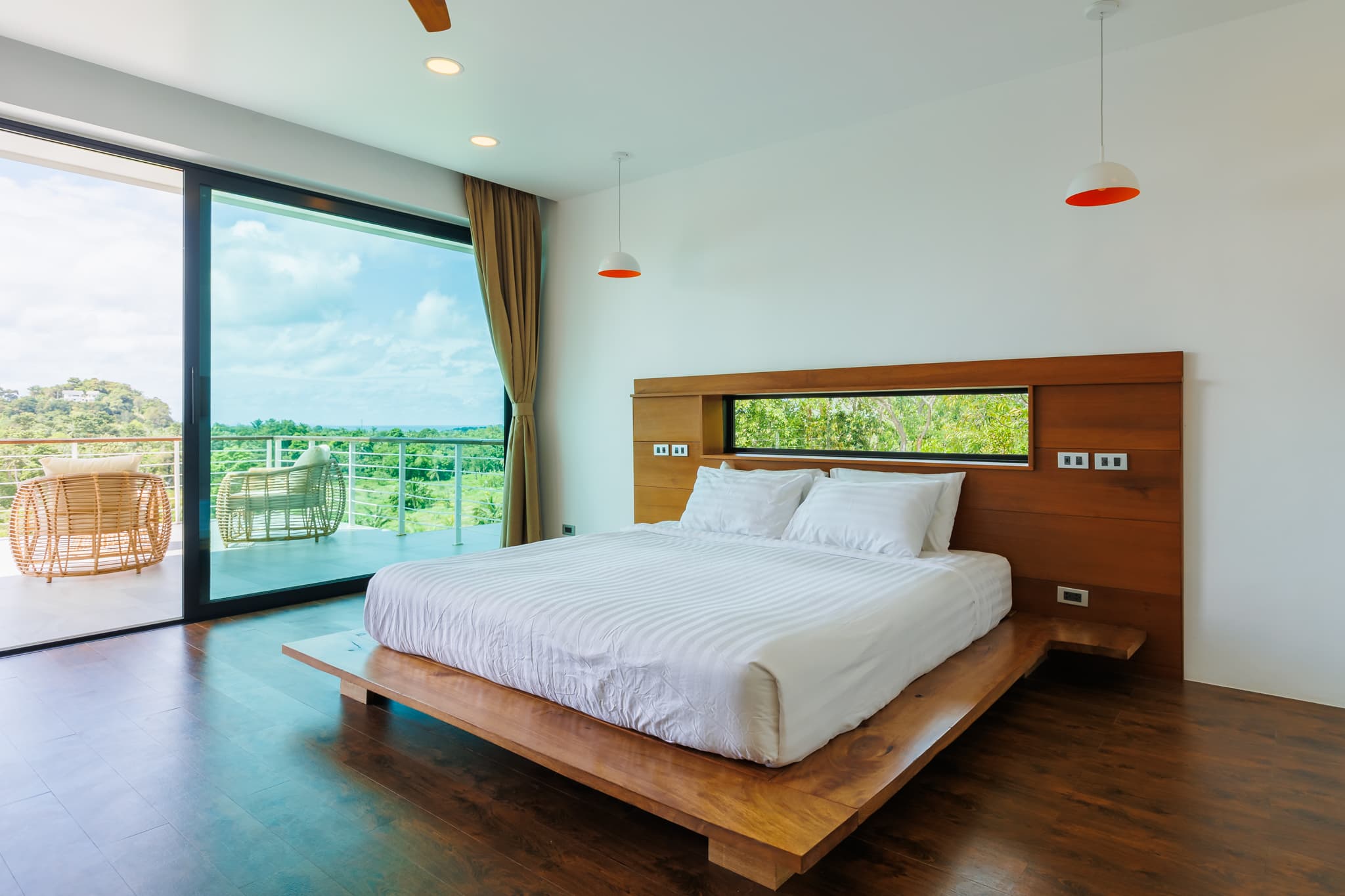 Master bedroom with platform bed and a balcony overlooking the bay at Villa Sekoya, Hin Kong Bay, Koh Phangan