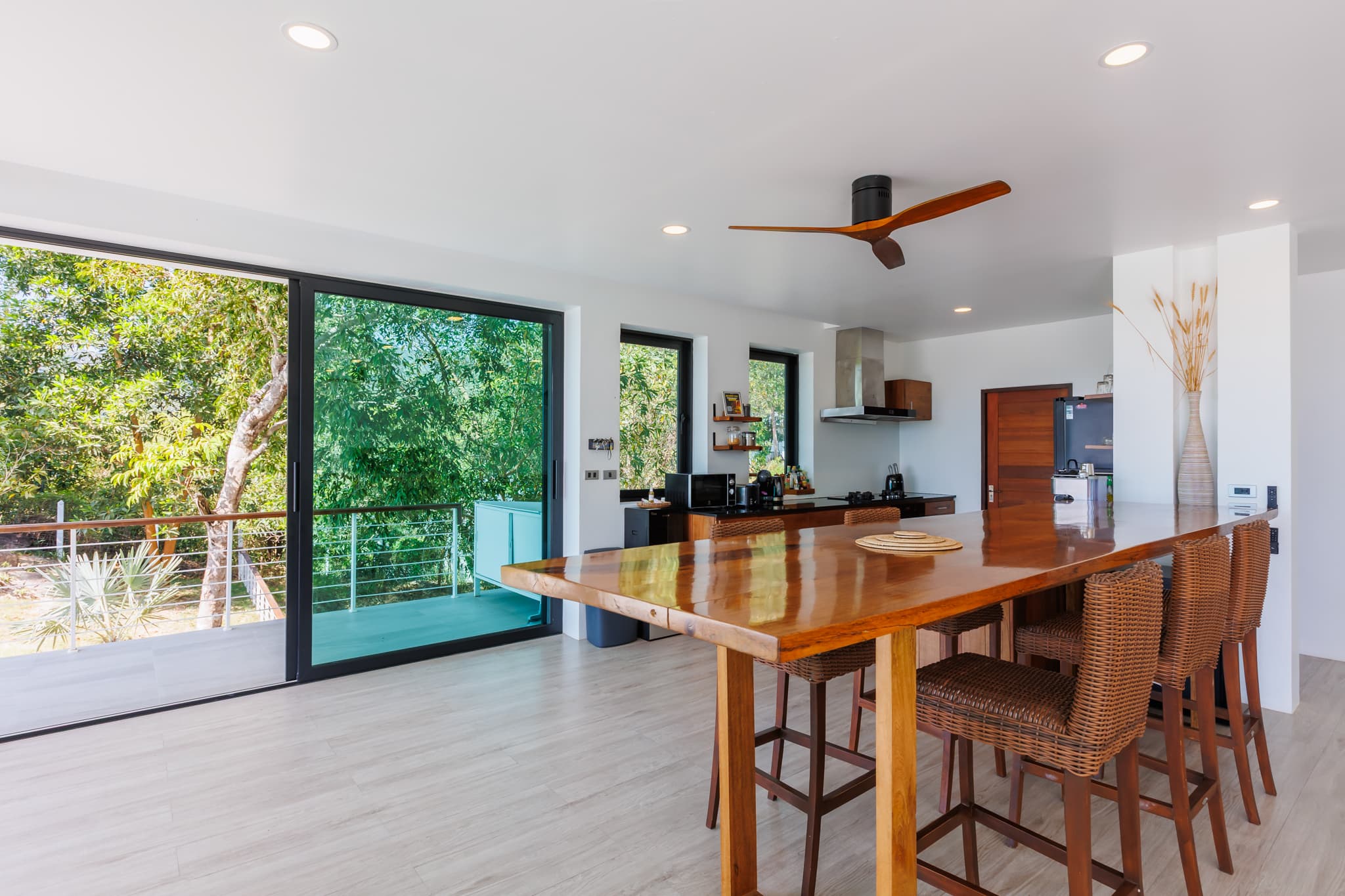 Open-plan dining area with a long wooden bar table, Villa Sekoya, Koh Phangan