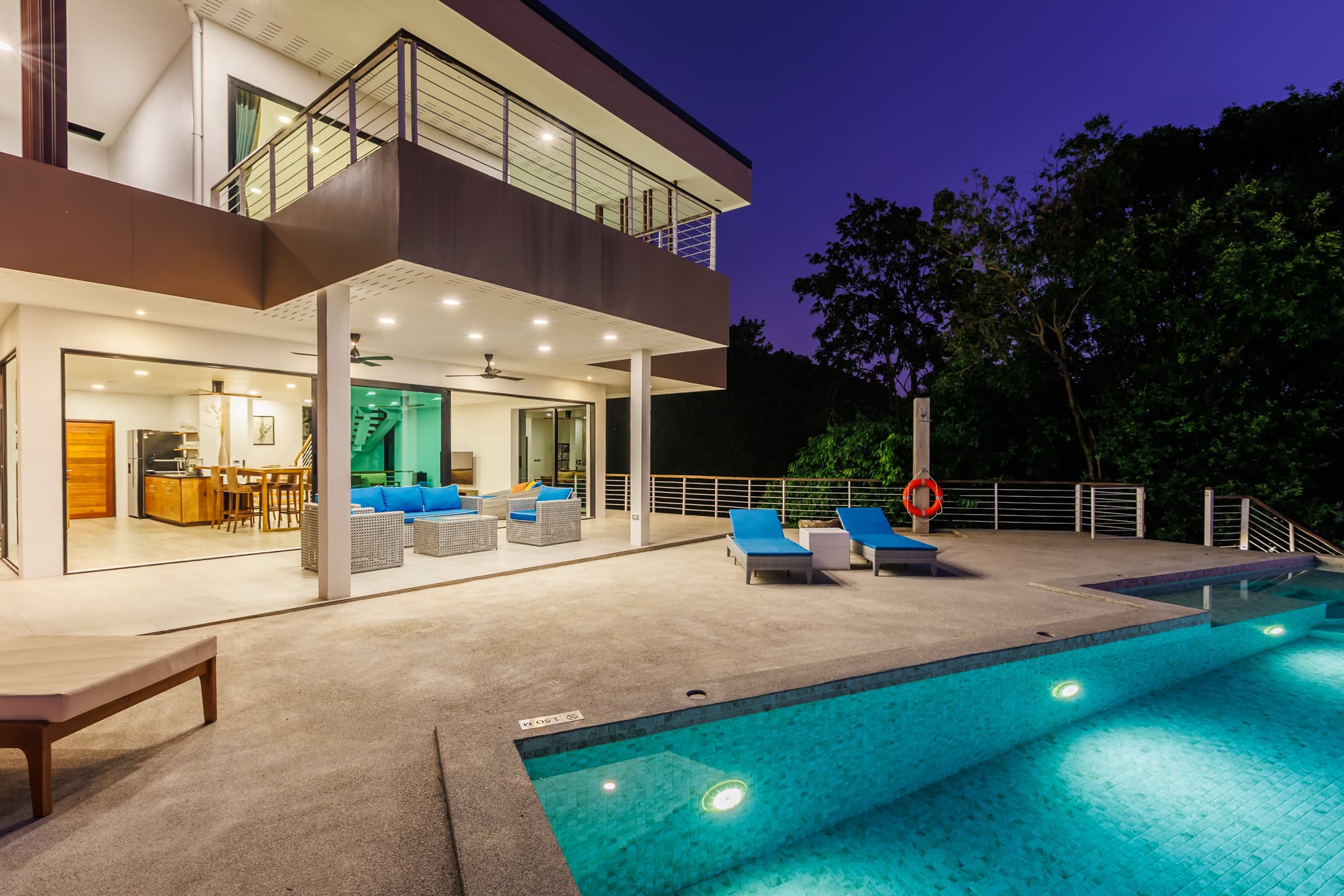 Illuminated pool terrace and villa at dusk, Koh Phangan